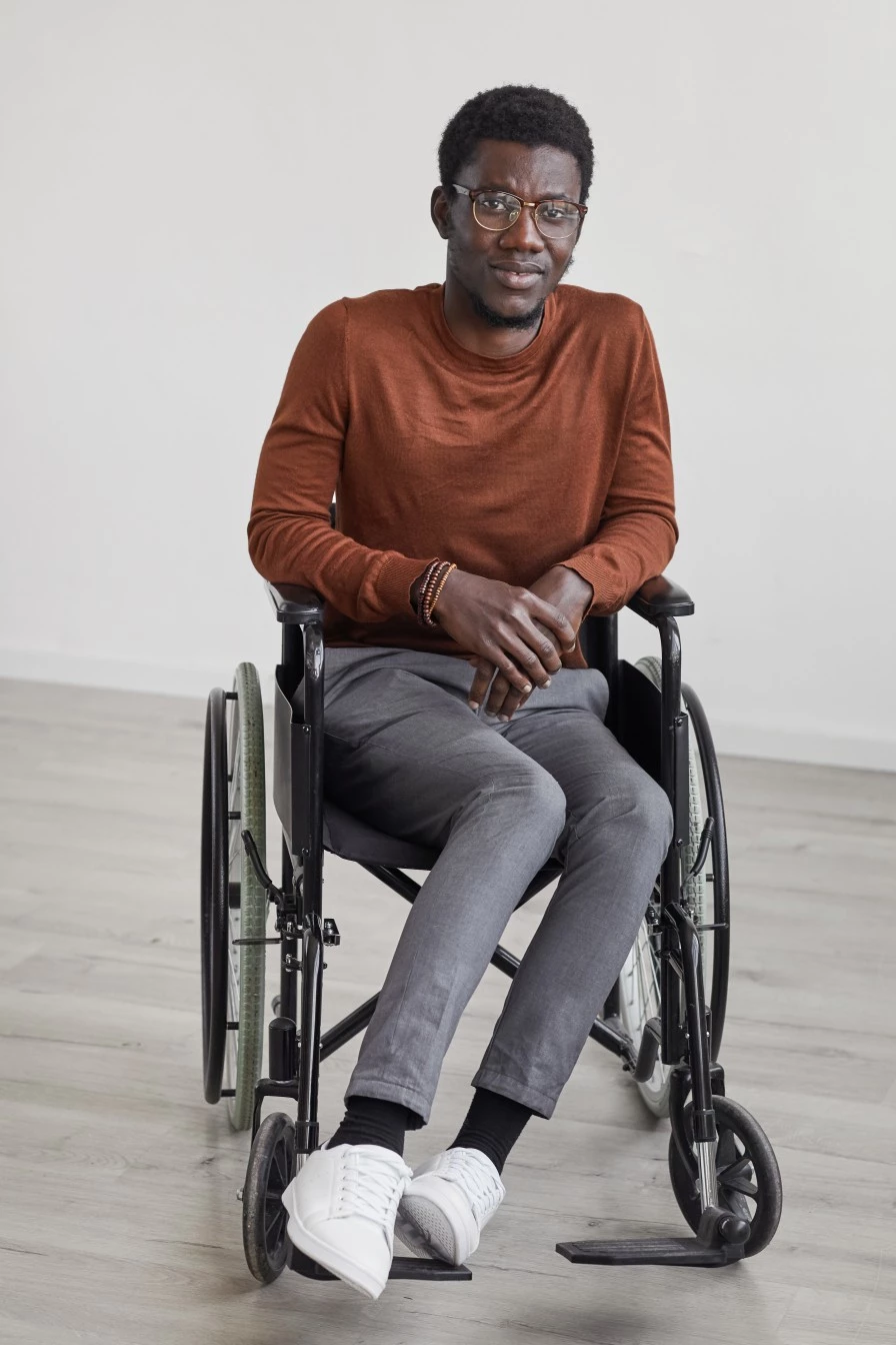 Disabled man in wheelchair smiling at camera